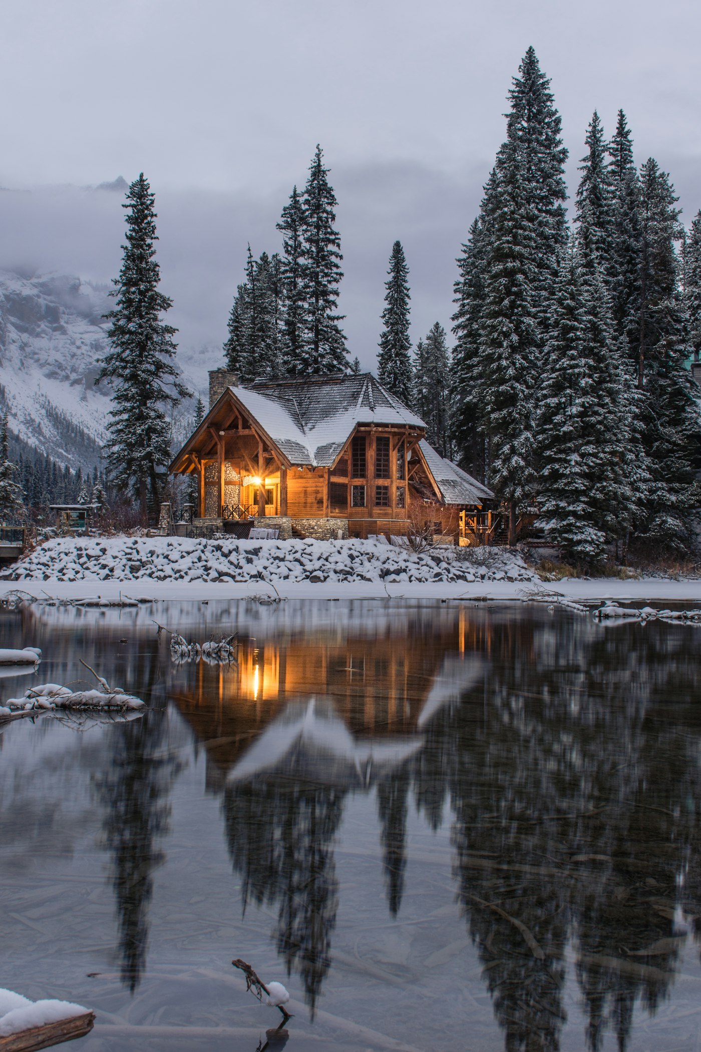 Snowy timber cabin with warm light in the windows